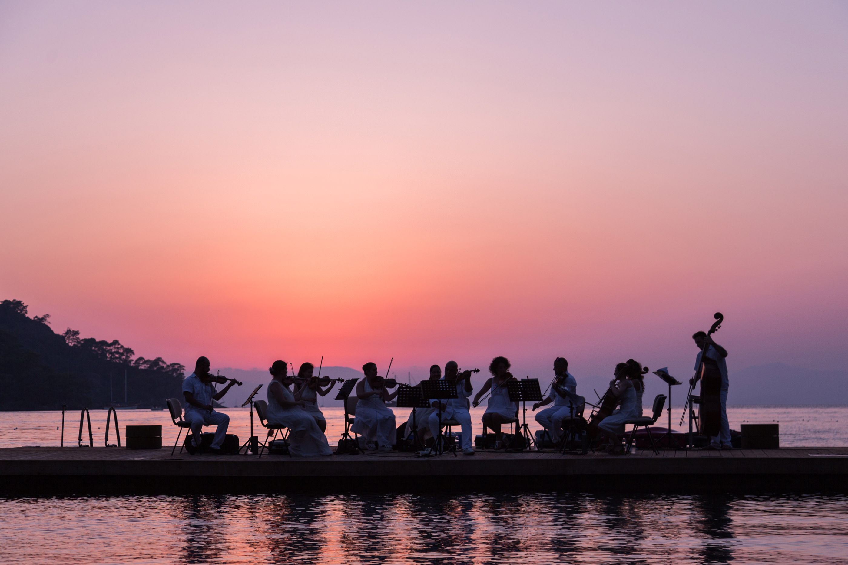 Sunset and Music Convene On The Sea